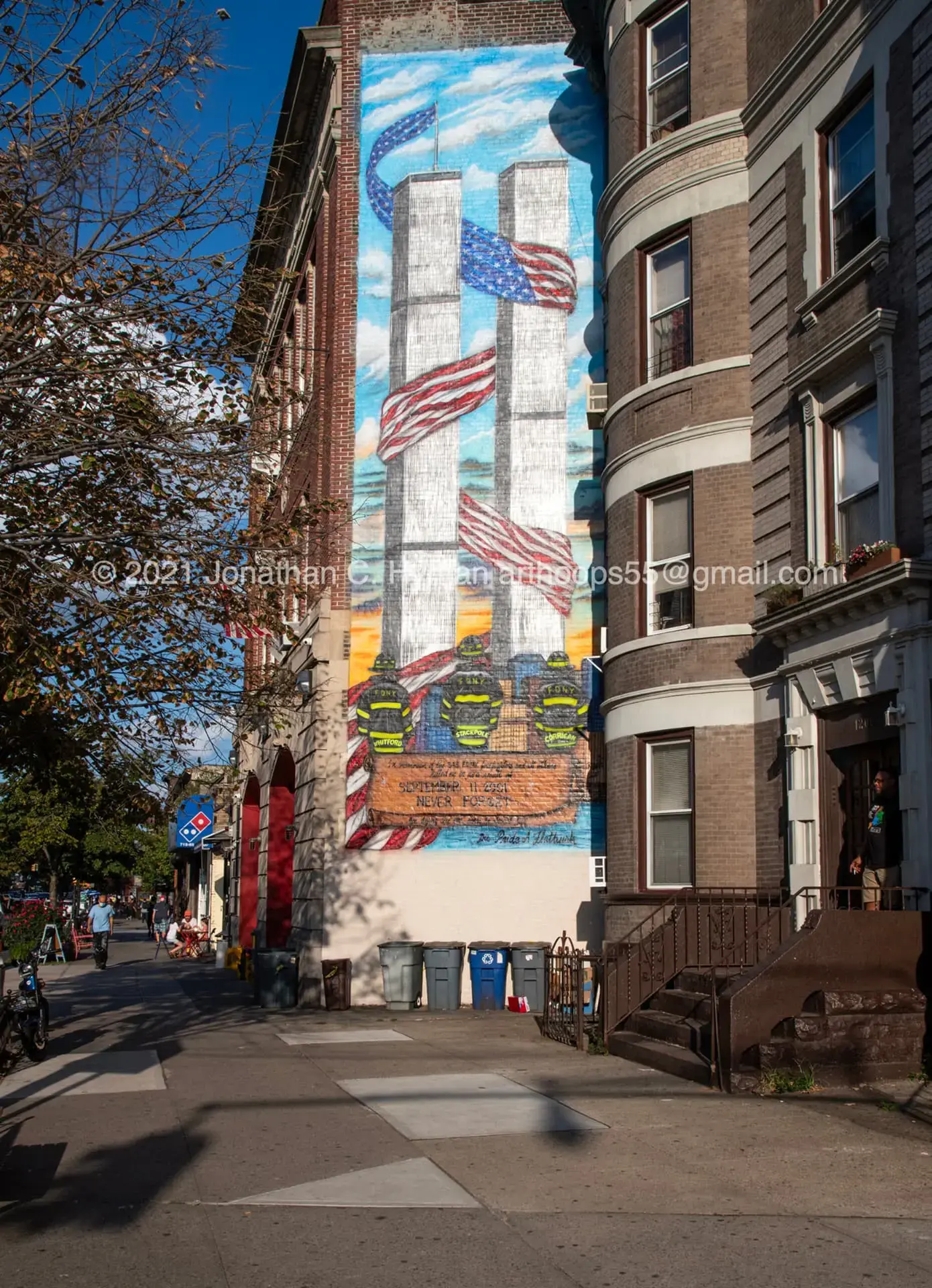 A hand-painted memorial tribute that includes the towers, flags, and firefighters